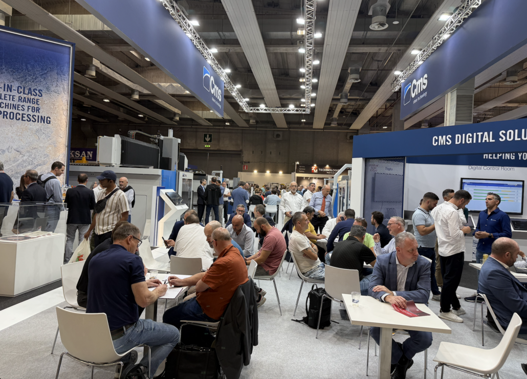 men sitting at tables at marmomc 2025